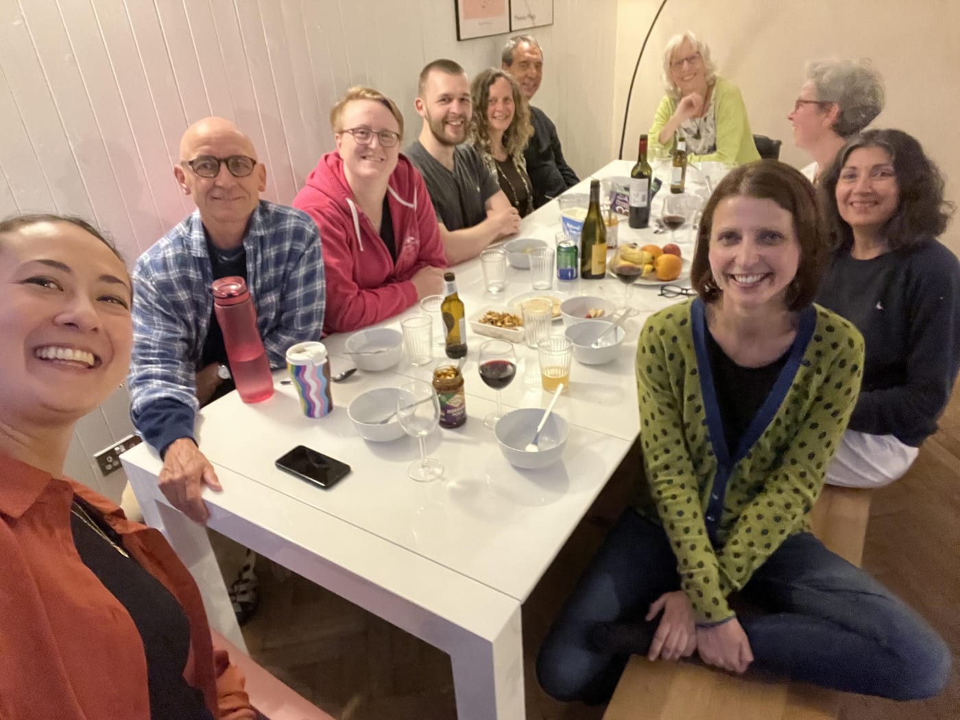 Photo of the Breathworks board and team members around the dinner table in the AirBNB