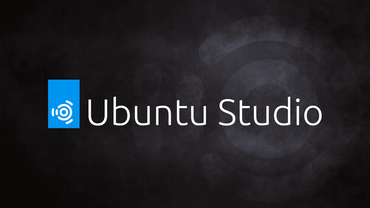 Ubuntu studio logo on the dark wallpaper which is black with a mottled grey image of the ubuntu studio logo on the right side - a circle with several concentric circles outside it.