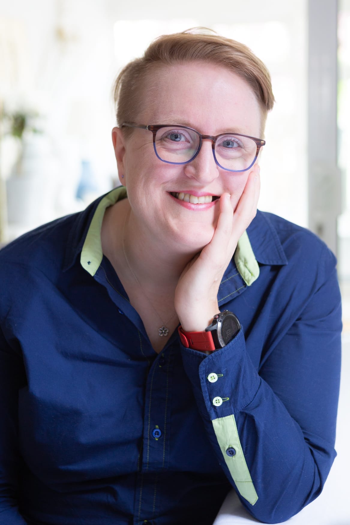 Sīlavāpi, smiling in natural window light